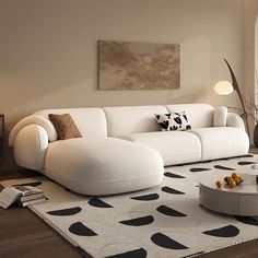 a living room with a white couch and black and white rugs on the floor