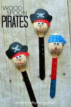 three wooden spoons made to look like pirates with faces painted on them and the words wood spoon pirates