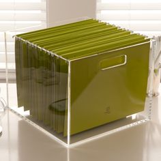 a green file cabinet sitting on top of a table