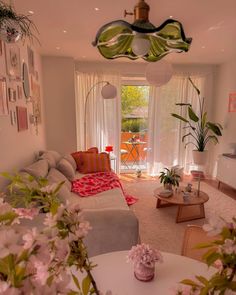 a living room filled with lots of furniture and flowers in vases on the table