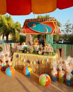 a table topped with lots of candy and beach balls