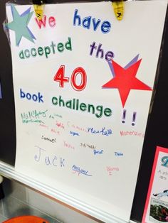 there is a sign that says we have accepted the 40 book challenge and an orange slice of pizza