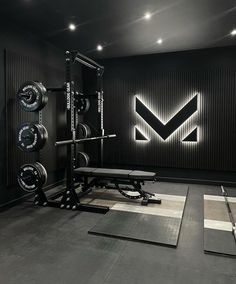 an empty gym room with black walls and flooring