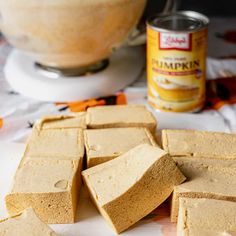 several pieces of peanut butter next to a can of pumpkin