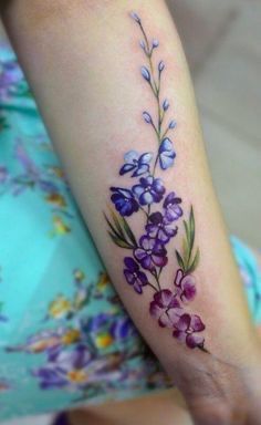 a woman's arm with purple flowers on it