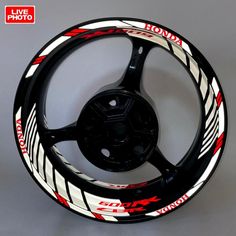 an image of a bike wheel cover with red and white designs on it's spokes