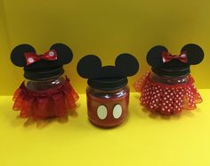 two jars with minnie and mickey mouse ears on them