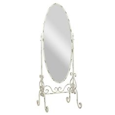 a white mirror sitting on top of a metal stand with an ornate design around it