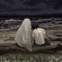 two people sitting on the beach at night