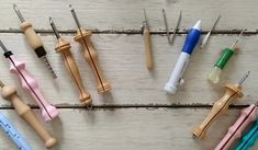 several different types of toothbrushes are arranged in a circle on a white wooden surface