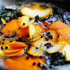 oranges and herbs are mixed together in a bowl