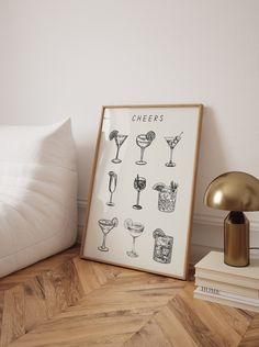 a framed photograph sitting on top of a wooden floor next to a lamp and pillows