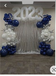 balloons and streamers in the shape of numbers are on display at an office event