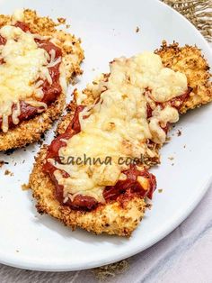 two pieces of chicken parmesan pizza on a white plate