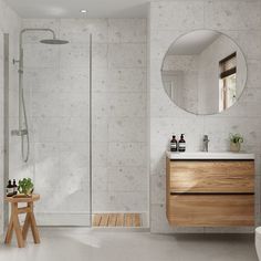 a bathroom with a sink, mirror and stand up shower in the middle of it