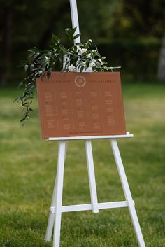 a sign with a plant on it in the grass