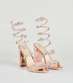 a pair of high heeled sandals with straps and crystal embellishments on the toes