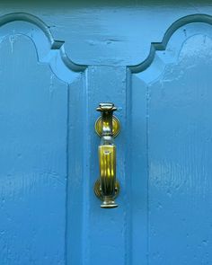 a blue door with a gold handle on it