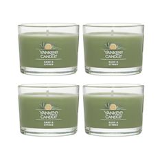 four yankee candle candles in glass holders