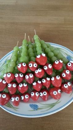 strawberries and grapes are arranged in the shape of eyeballs on a platter