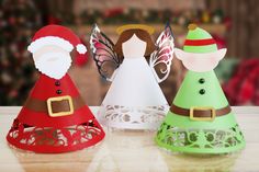 three paper christmas hats on a table