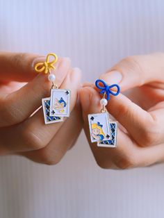 ⭐️ Introducing our kawaii earrings that are added to the new collection ENAMEL KAWAII Link: https://www.etsy.com/shop/EasternDragonShop?ref=shop-header-name&listing_id=1529609045&from_page=listing&section_id=48840336 ⭐️ The dangles showcase intricately designed cute elements, adding a unique touch to your look. The design features a rabbit shape hoop with a string of poker cards in the middle.  ⭐️ Crafted with hypoallergenic materials, these earrings offer a comfortable and safe wearing experien Alice In Wonderland Earrings, Cute Alice In Wonderland, Rabbit Shape, Kawaii Earrings, Poker Cards, Cheshire Cat, Daily Outfits, Wedding Shop, Alice In Wonderland