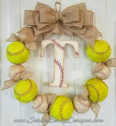 a wreath made out of baseballs and burlocks with the letter t on it