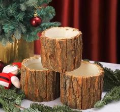 three pieces of wood sitting on top of a table next to a christmas tree and other decorations