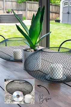 two metal baskets with plants in them sitting on a table