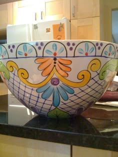 a colorful bowl sitting on top of a kitchen counter