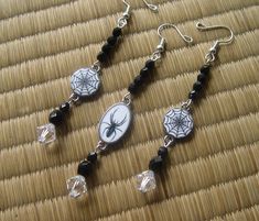 two spider web dangle earrings with black beads and crystal bead drop earwires