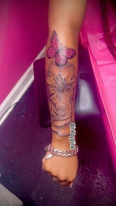 a woman's foot with a butterfly tattoo on her left leg and pink background