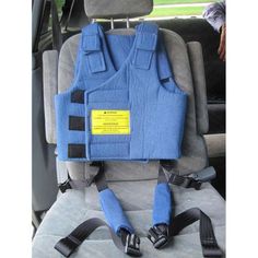 a car seat with an attached harness to it's back and two straps on the front