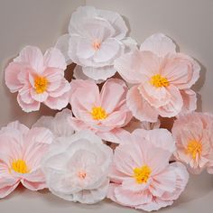 pink and white paper flowers arranged in a row