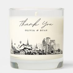 a white candle with the words thank you written in black ink on top of it