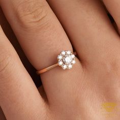 a woman's hand with a diamond ring on top of her finger and an engagement band