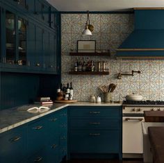 a kitchen with blue cabinets and white counter tops is pictured in this image, there are shelves on the wall above the stove