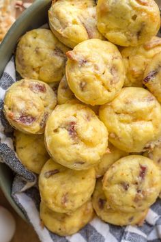 a bowl filled with muffins sitting on top of a table