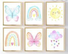 four watercolor paintings with rainbows, clouds and hearts on them in different frames