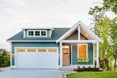 a blue and white house with two garages