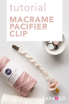 the macrame pacifier clip is shown next to some yarn and other items