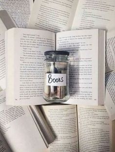 an open book with a jar full of books on top of it and the words books written in black ink