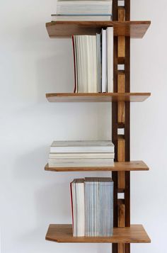 three wooden shelves with books on them