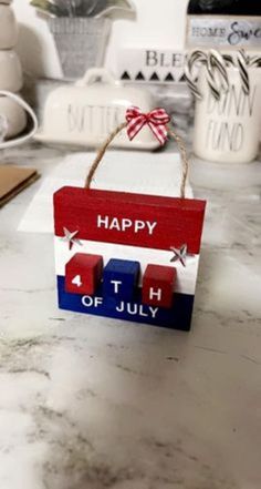 a wooden sign that says happy fourth of july on it with red, white and blue blocks