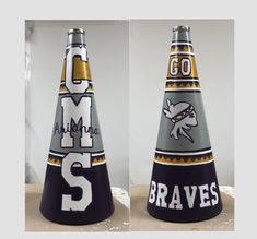 two black and gold cones with the letters ms and m on them are shown in three different angles