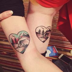 two people with matching tattoos on their arms