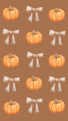 pumpkins with bows and ribbons are shown in this watercolor painting pattern on a brown background