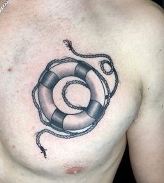 a man's chest with a life preserver tattoo on it