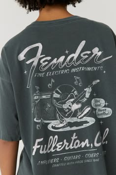 Site of Fender’s original factory, Fullerton CA was needless to say home to countless iconic guitars that transformed nearly every music genre. Because Fender slapped “Fullerton, California” on each of their stringed instruments, their headquarters became known worldwide. Illuminated in silver glitter, Fender’s merch tee lights up their musical contribution over the years with a guitar playing record graphic and feature of their household name. A blend of our Weekend Tee and OS Tee, this tee is Record Graphic, Guitar Playing, Music Genre, Faux Leather Top, Stringed Instruments, Ladder Stitch, Champion Sweatshirt, Rainbow Kids, Tour Shirt