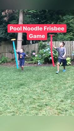 two young boys are playing frisbee in the yard with a sign that says pool noodle frisbee game